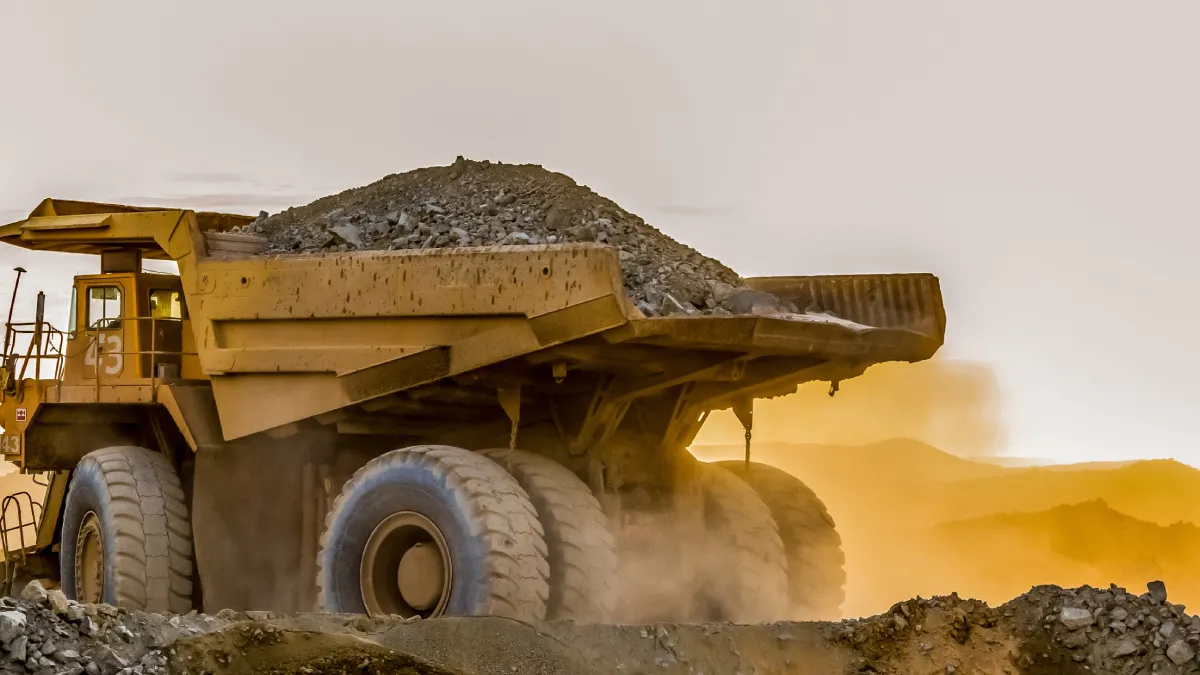 large truck carrying sand platinum mining site